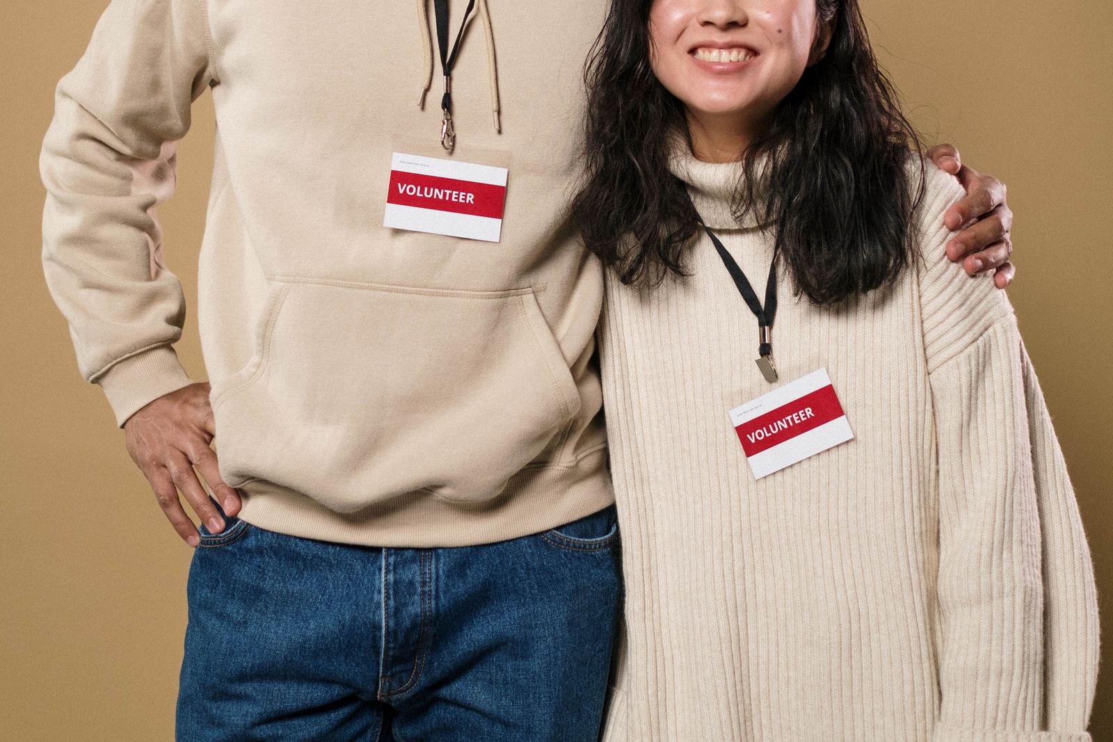 Two volunteers wearing volunteer badges