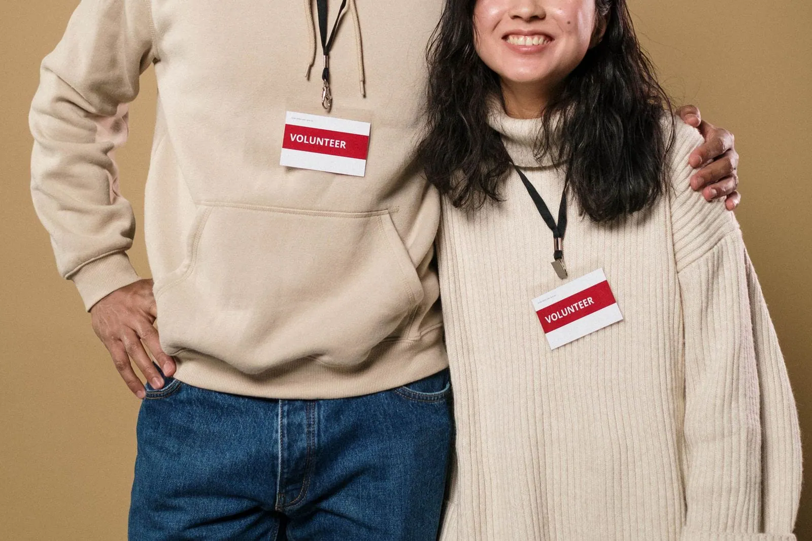 Two volunteers wearing volunteer badges